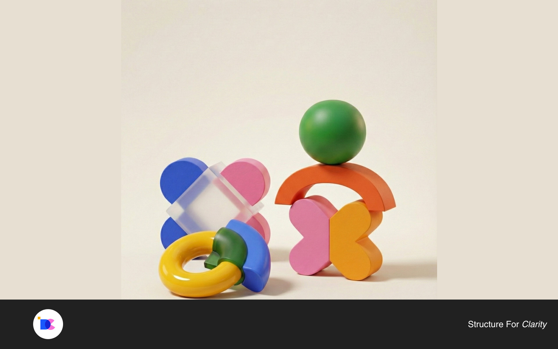 A sculptural family of colourful ceramic circles, arches and geometric forms on a warm background.