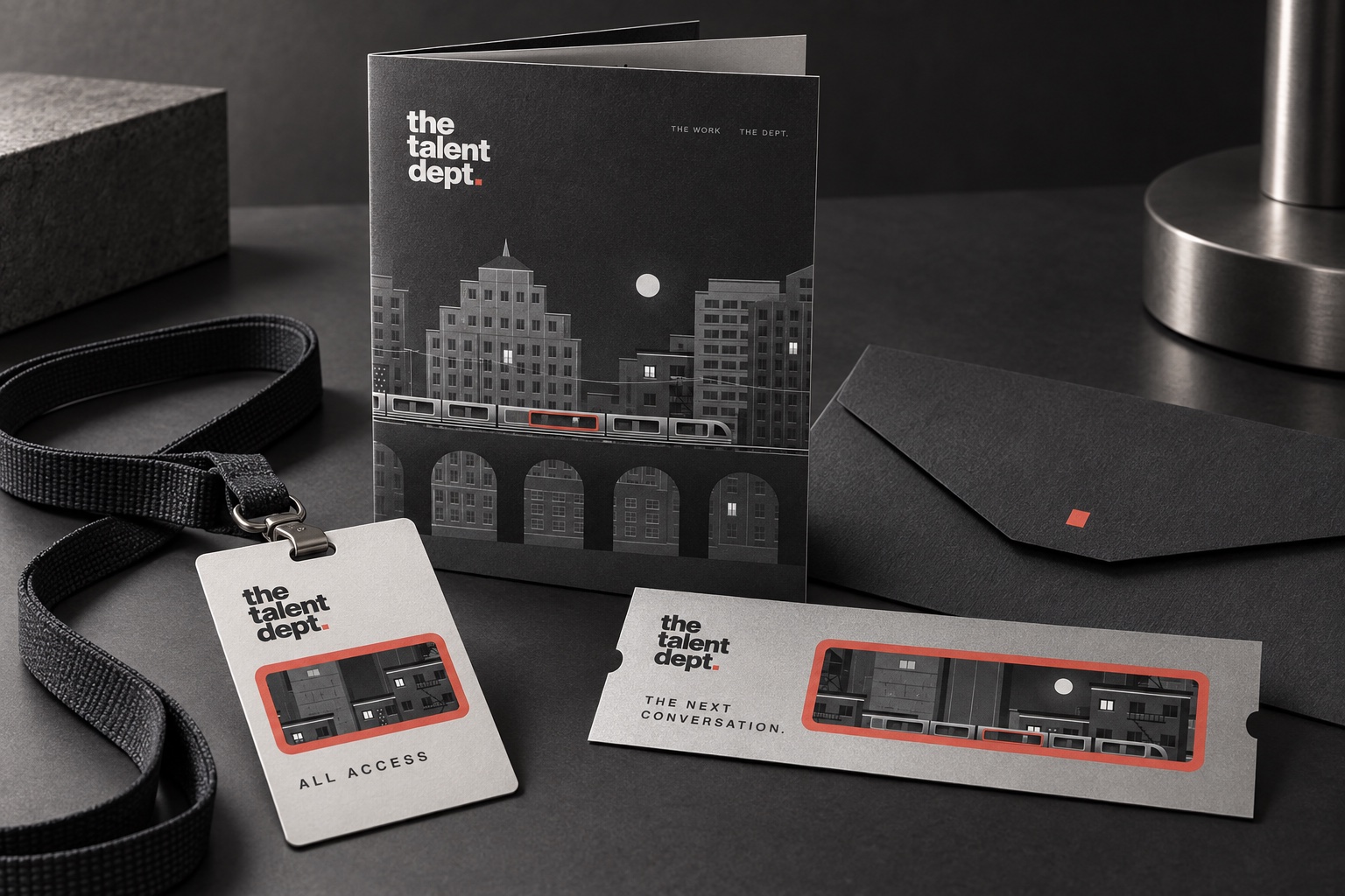 The Talent Dept. event programme, lanyard pass, envelope and ticket using monochrome city artwork and coral window frames.