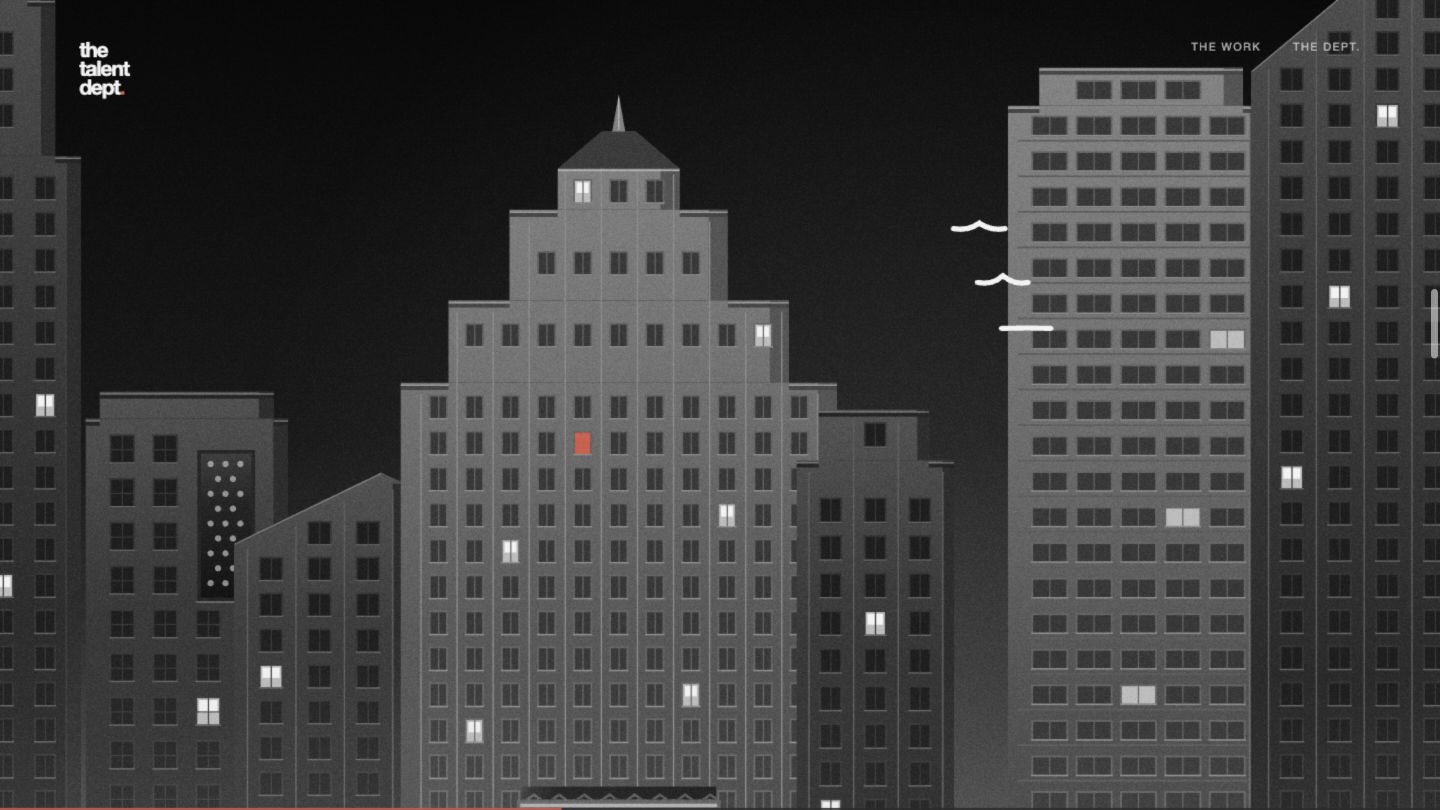 The camera approaches a coral window in a geometric building façade